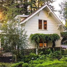 Classic White Cottage with Lush Greenery