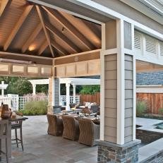 Gray Covered Patio With Wicker Chairs