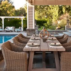 Tan Outdoor Dining Area With Wicker Chairs