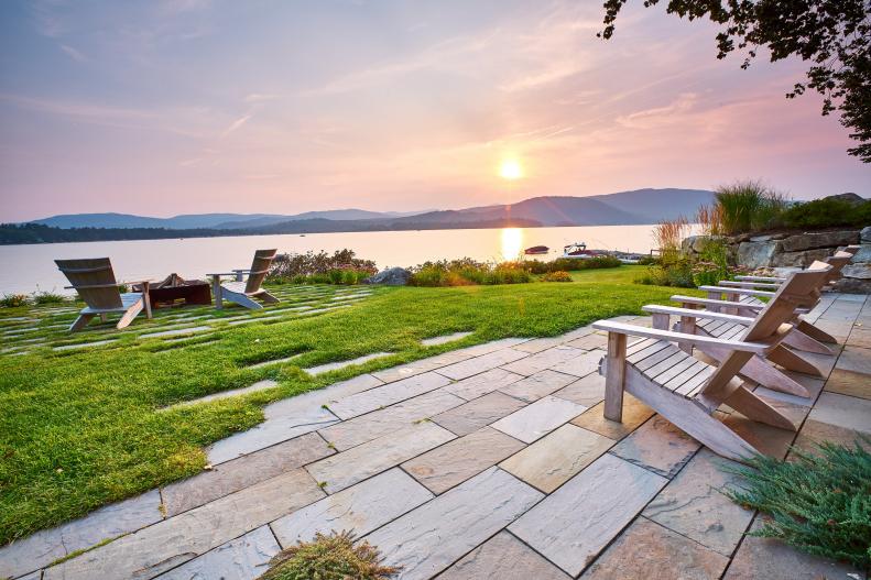 This breathtaking view from the terrace showcases the backyard's patio with an eye-catching fire pit.