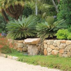 Tropical Garden With Tan Stone Wall