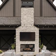 White Stone Fireplace and Gray Chairs