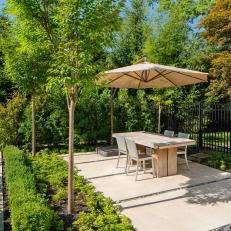 Outdoor Dining Area With Tan Umbrella