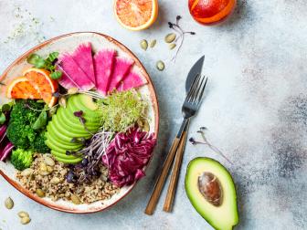 Vegan, detox Buddha bowl with quinoa, micro greens, avocado, blood orange, broccoli, watermelon radish, alfalfa seed sprouts. Top view, flat lay, copy space 