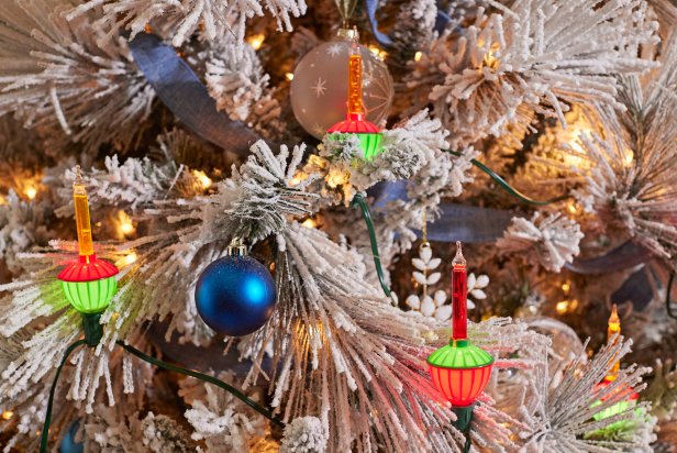 putting lights on a Christmas tree