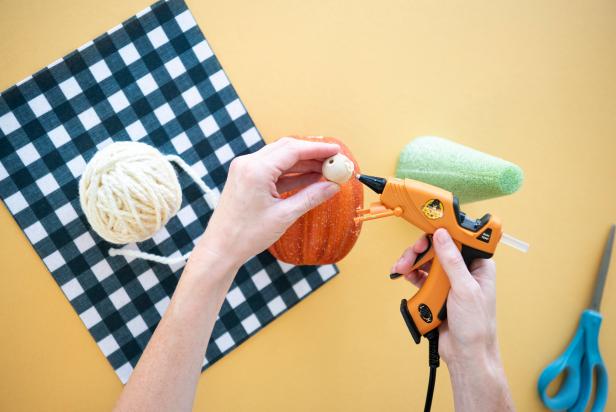 This simple fall DIY is fast and beginner-friendly. A wooden bead serves as the nose for the pumpkin gnome, and yarn adds the eyebrows and beard. Fully customize this autumn decor by changing the size of the pumpkin, color of yarn, or size of the bead.