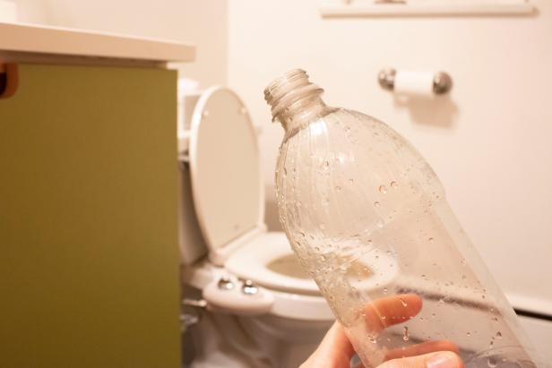 Water bottle clearing a toilet blockage.