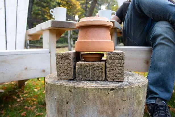 Terra cotta pot and saucer constructed to amplify heat source.