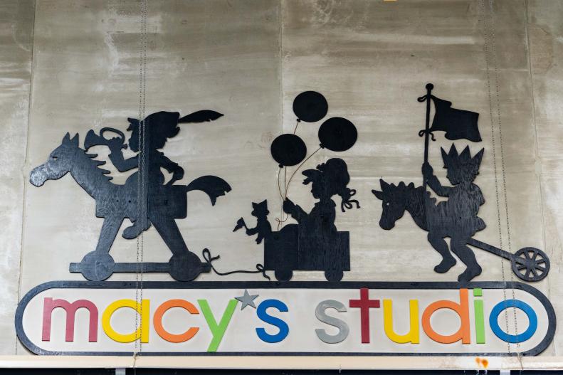 A large sign for the Macy's Studio painted on an interior wall.