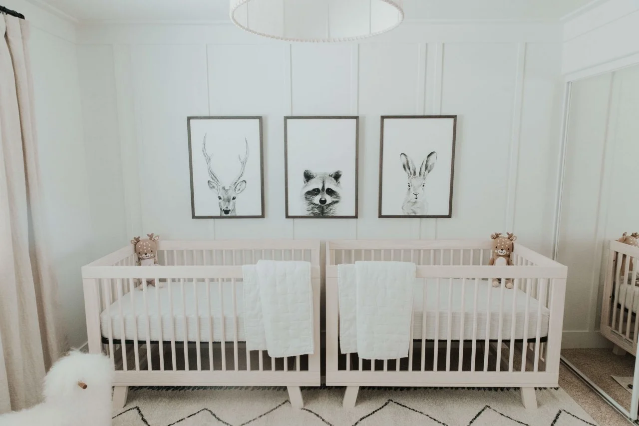 Modern twin nursery organization with baskets and cabinets