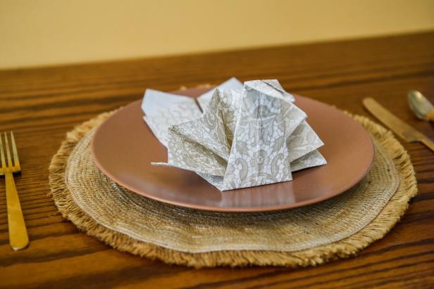 Easily overhaul your Thanksgiving tablescape by giving each place setting its own turkey napkin. With a few quick folds, you can turn paper napkins into turkeys. This is a great way to add an elegant and elevated look to your Thanksgiving table without splurging on cloth napkins.