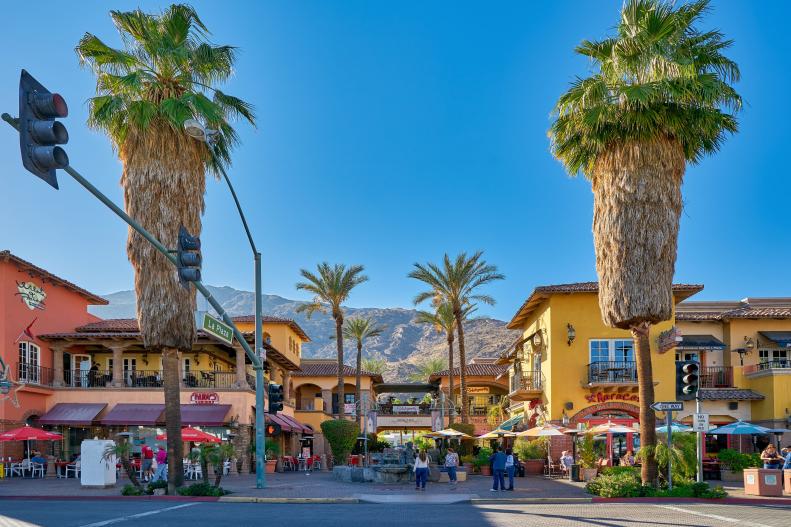 Shops, shoppers and palm trees along the street in downtown Palm Springs.