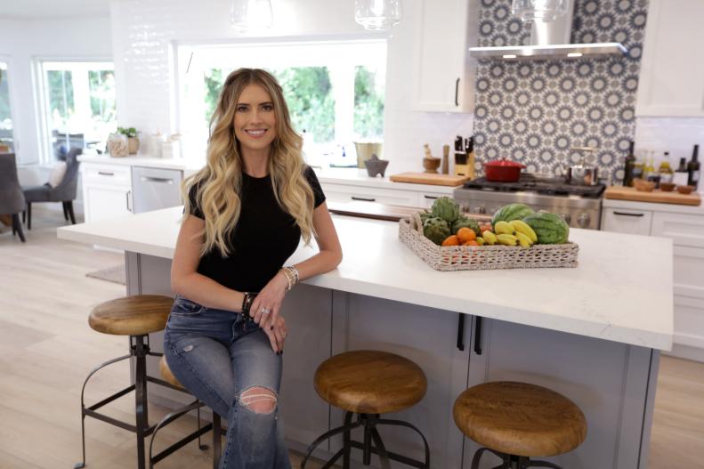 Christina Hall sits in the Guzman's new kitchen after the renovation, as seen on Christina on the Coast, Season 4.