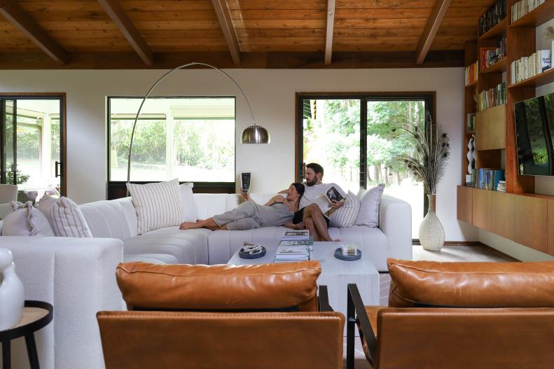 A Man and Woman Lounging on a White Sofa