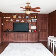 Before: A Dark Den With Wood Paneling