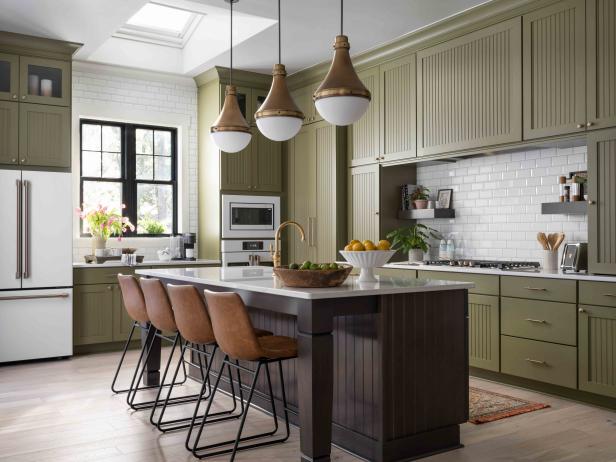 The heart of the home features olive-green cabinets, a hidden pantry and state-of-the-art smart appliances.