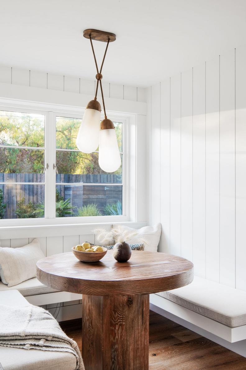 Breakfast Nook With Wood Table and Brass Pendant