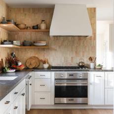 Earthy Kitchen With Zellige Tiles and Dark Limestone Countertops
