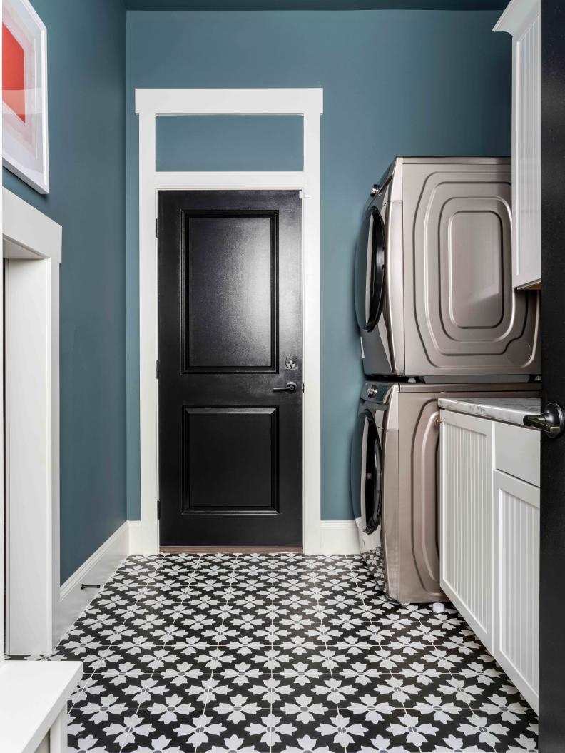 The laundry room’s patterned tile floor adds color and personality to this super-efficient and organized space. 