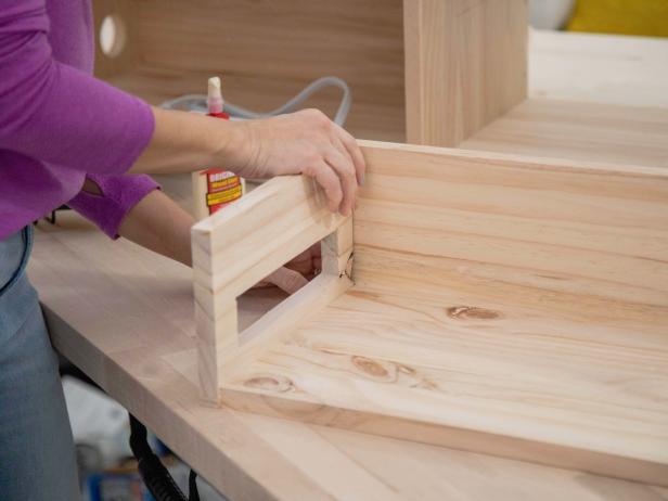 Add wood glue and attach the drawer side piece you just modified to the 9-3/4&quot; x 16&quot; base. Attach the 5-1/2&quot; x 17-1/2&quot; piece as the back and the other 6&quot; x 9-3/4&quot; piece without the power strip hole as the right side.