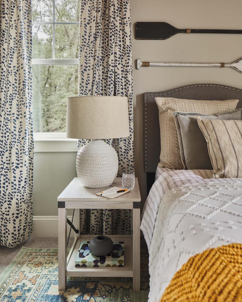 Mixing organic textures with the wood side table, cotton bedding and botanical inspired prints infuses the room with a soothing feel that invites relaxation and rest.