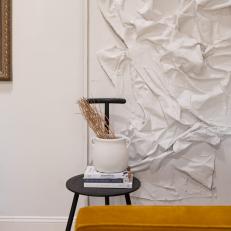 White Sculpture and Black Chair