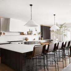 Black and White Open Plan Kitchen With Black Island