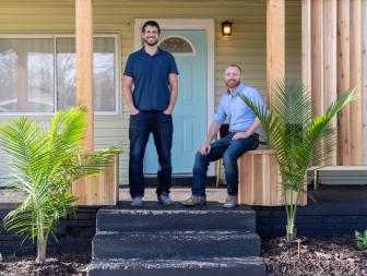 Partners Evan Thomas (L) and Keith Bynum (R) pose outside a home they renovated, as seen on HGTV's Bargain Block.