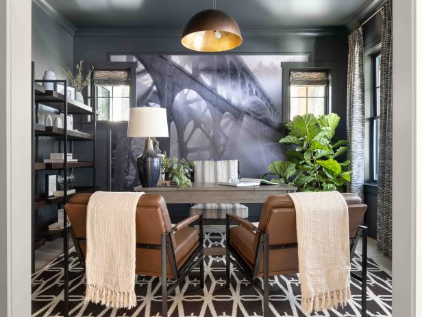 A curated selection of furnishings, industrial style dome pendant, and dramatic wall mural are some of the design details in this well-appointed home office, that offers a fashionable spot to get things done. 