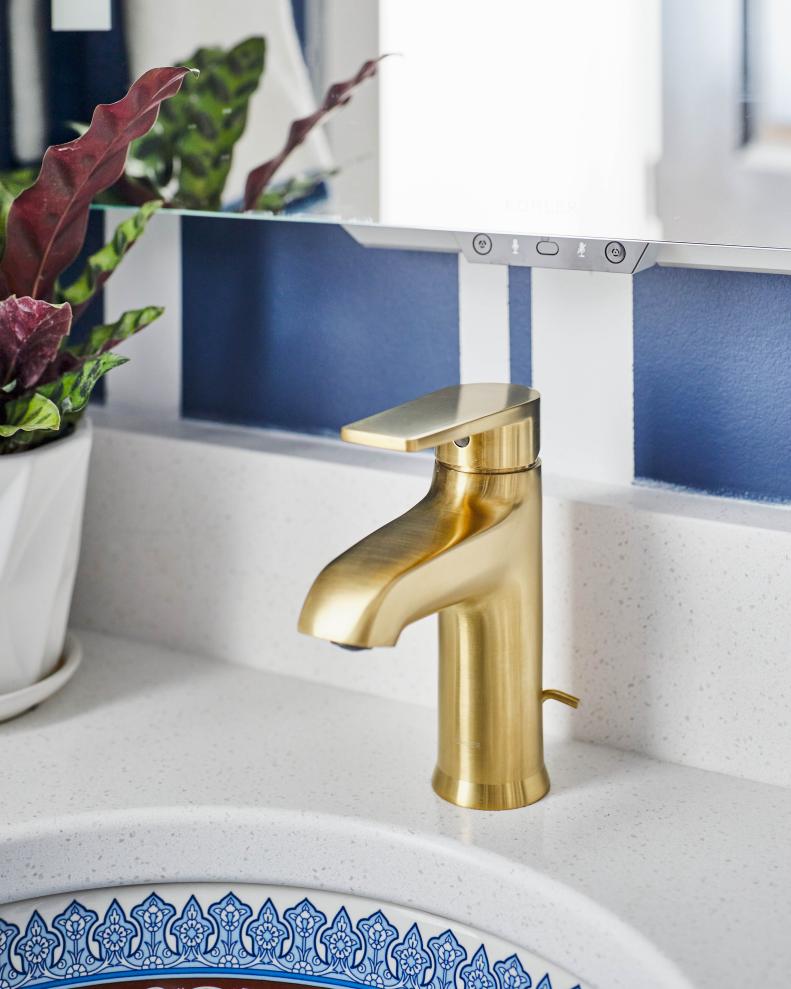 The single lever handle of the vanity’s minimalist sink faucet with a beautiful brushed brass finish allows for simultaneous on/off activation and temperature setting. 