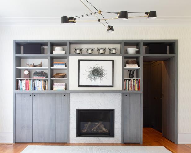 Grey shelving unit with open hidden door 