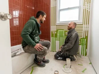 Keith and Evan taping and painting at the bathroom of the Greenview home