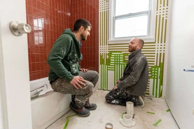 Keith and Evan taping and painting at the bathroom of the Greenview home