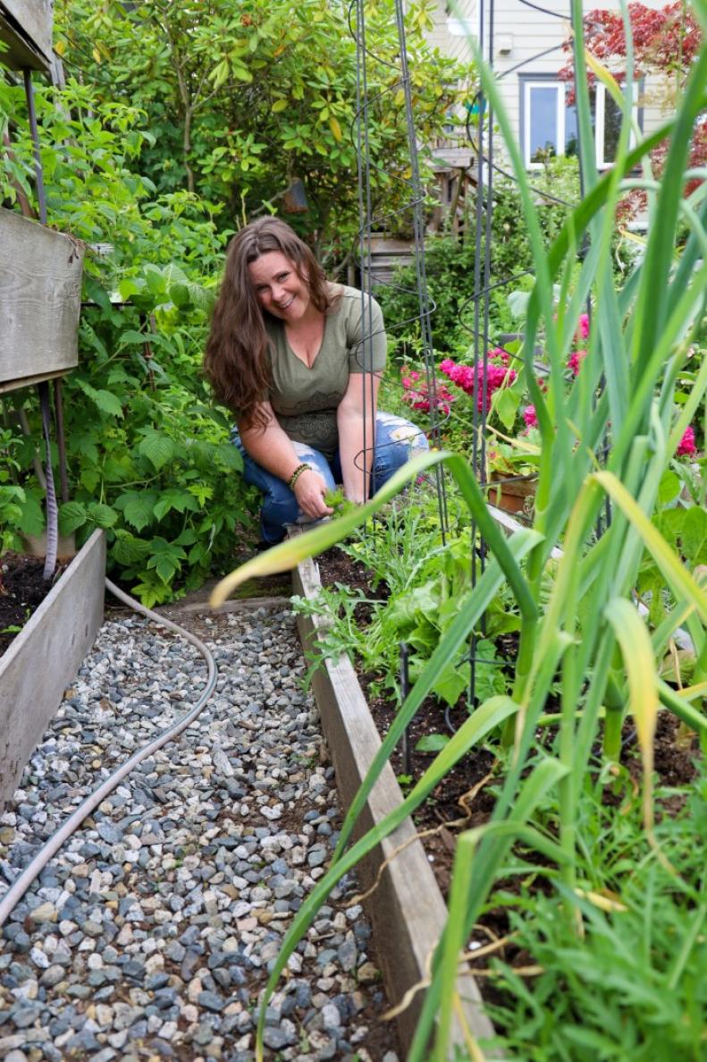Stephanie Rose by a raised bed in her Vancouver garden