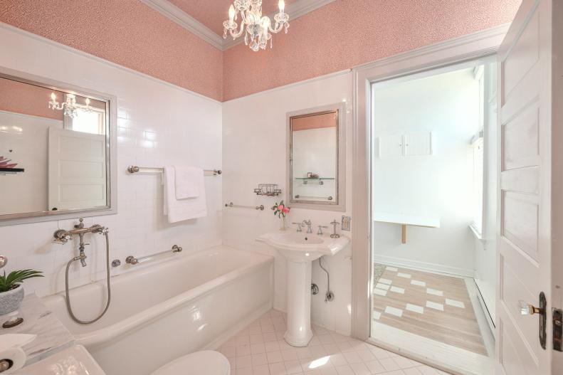 Bathroom with walk-in shower and pink texture on the upper walls.