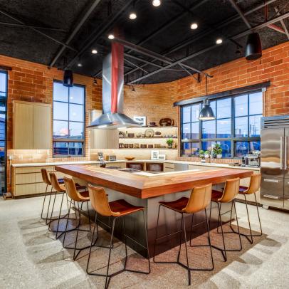 Industrial Kitchen With Brick Walls, Exposed Ceiling and Dine-In Island