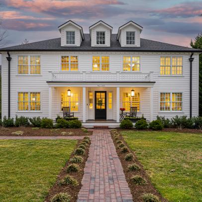 White Colonial Home With Brick Walkway