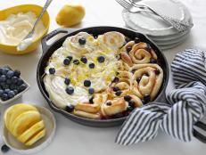 Brunch guests will love this springtime twist on traditional cinnamon rolls. Sweet lemon curd and fresh blueberries are rolled up together in our favorite yeast dough and baked farmhouse-style in a cast iron skillet. Smother the warm rolls with plenty of lemony cream cheese frosting for an ooey-gooey finish.