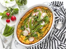 Tender spring asparagus and fresh peas bring garden flavor to this cheesy frittata. Grab an extra carton of eggs at the farmer’s market while shopping for produce. This herby, eggy dish requires an entire dozen.