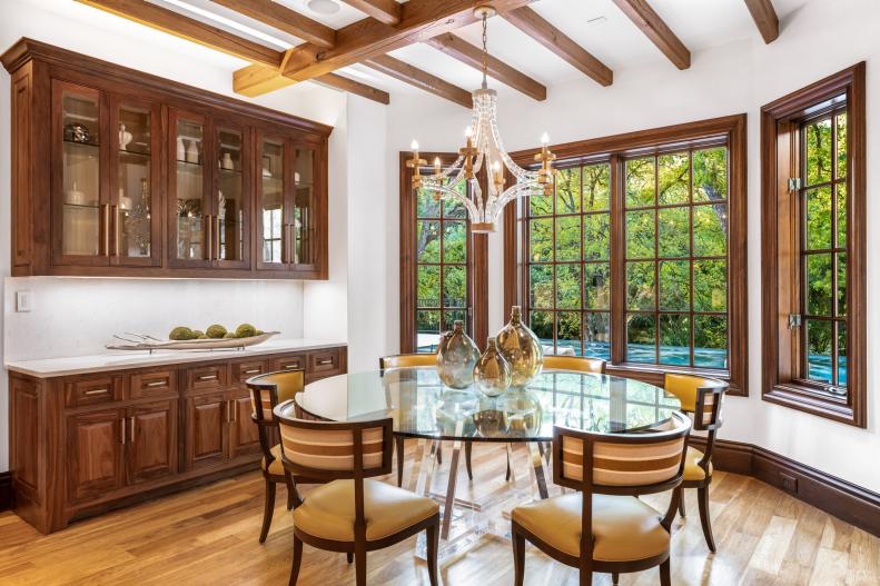 White nook with bay windows and exposed beams.