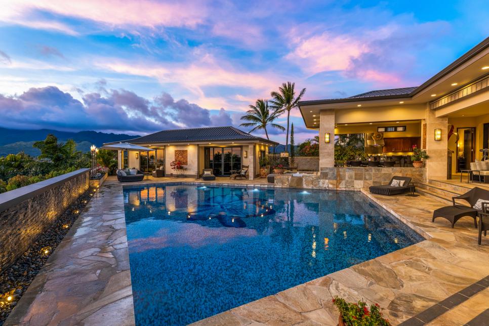 Tropical pool deck with irregular stone pavers and covered patios.