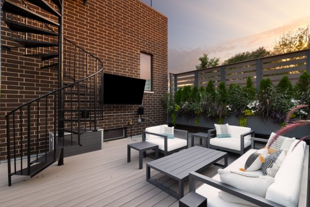ELMHURST, IL, USA - JULY 20, 2021: A beautiful patio at sunset on a red brick home with a black spiral staircase, composite decking, furniture, and a mounted television.