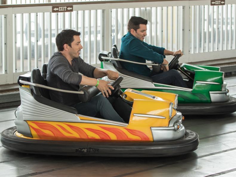 Jonathon and Drew Scott ride the bumper cars at the historic Pleasure Pier in Galveston, TX, as seen on Brother vs. Brother.
