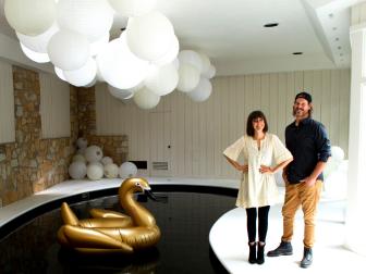 As seen on Restored by the Fords, Leanne and Steve Ford pose in the renovated interior pool room in the Collins House