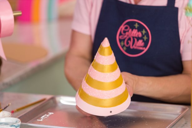 Use your pencil to make a mark about a half inch from the bottom of the hat, then make a second mark on the opposite side of the hat (Image 1). Use the ruler to help make the marks even if necessary. Then, use a small hole punch to punch out the holes at the marks (Image 2).