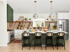 Colorful Kitchen With Tile Backsplash and Green Island