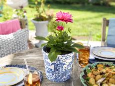 HGTV's design-on-a-dime pros share how to give a plain terra cotta pot a trendy, high-end Chinoiserie makeover using just paper napkins and decoupage medium.