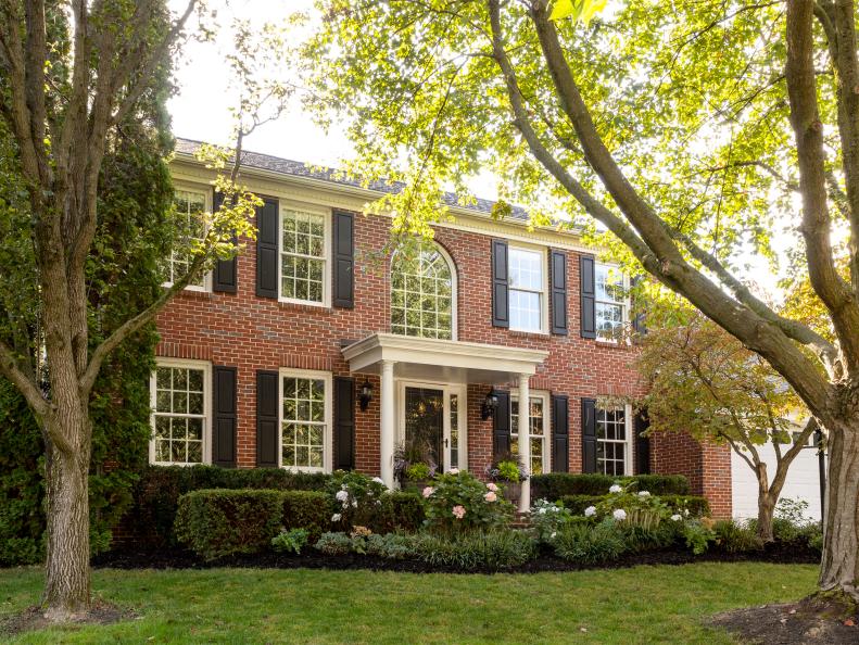 Colonial Home with Red Brick and Black Shutters