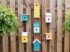 Colorful Birdhouses on a Fence