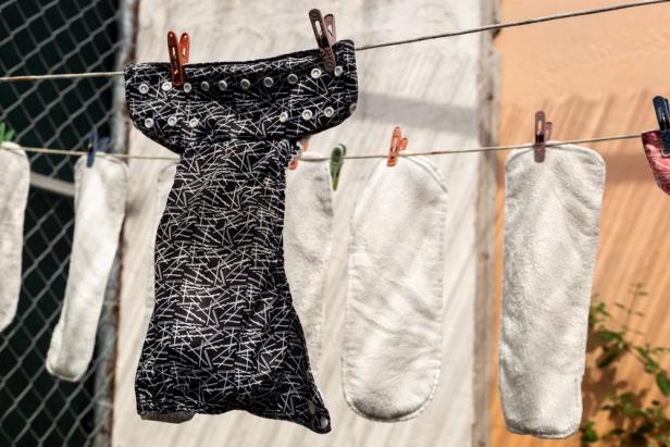 Cloth diapers hanging outdoors to dry on a clothesline